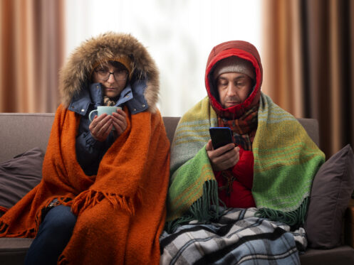 Couple in parkas, heater shut down